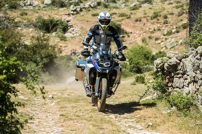 Guy riding BMW motorcycle off road